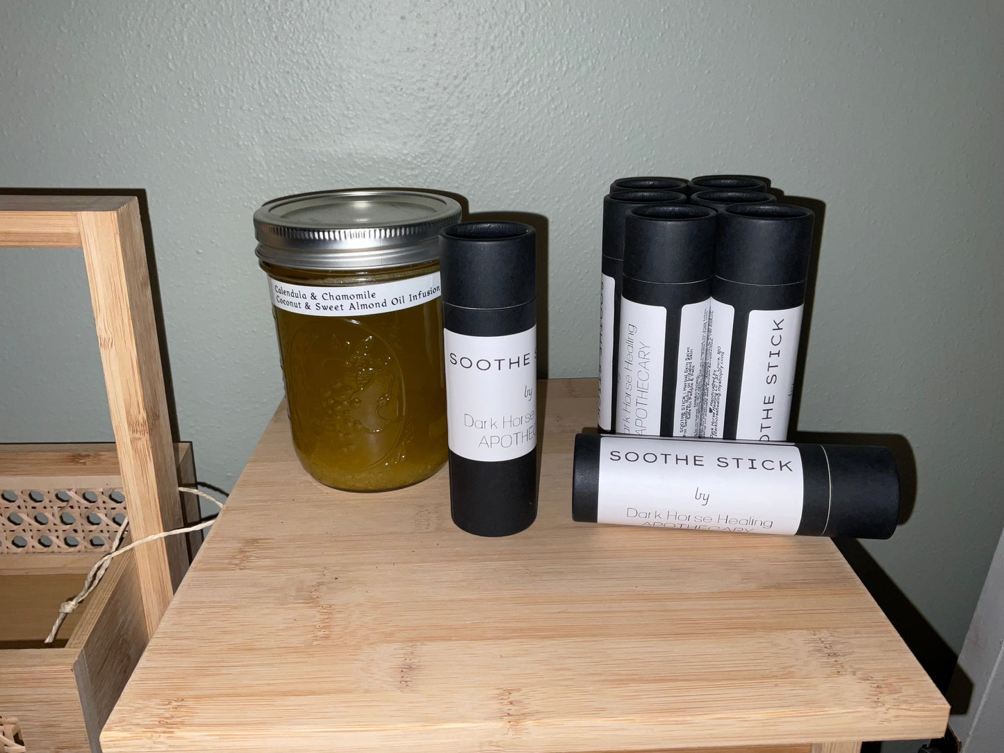 Soothe Stick Herbal Healing Balm for dogs with organic ingredients displayed on a wooden shelf.